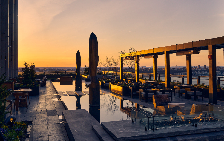 Luxury bar with modern decor, well-lit shelves, bar stools, and plush seating area.
