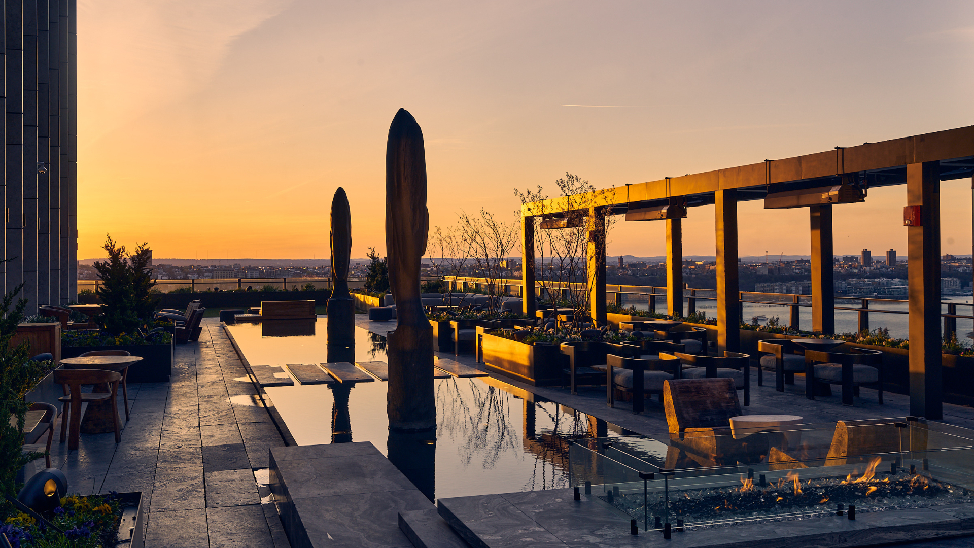 Modern bar area with high stools, shelves, and light wood tones.